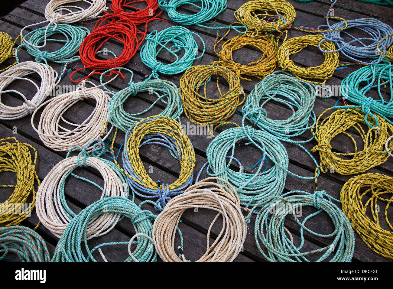 Coils of fishing rope on dock Stock Photo
