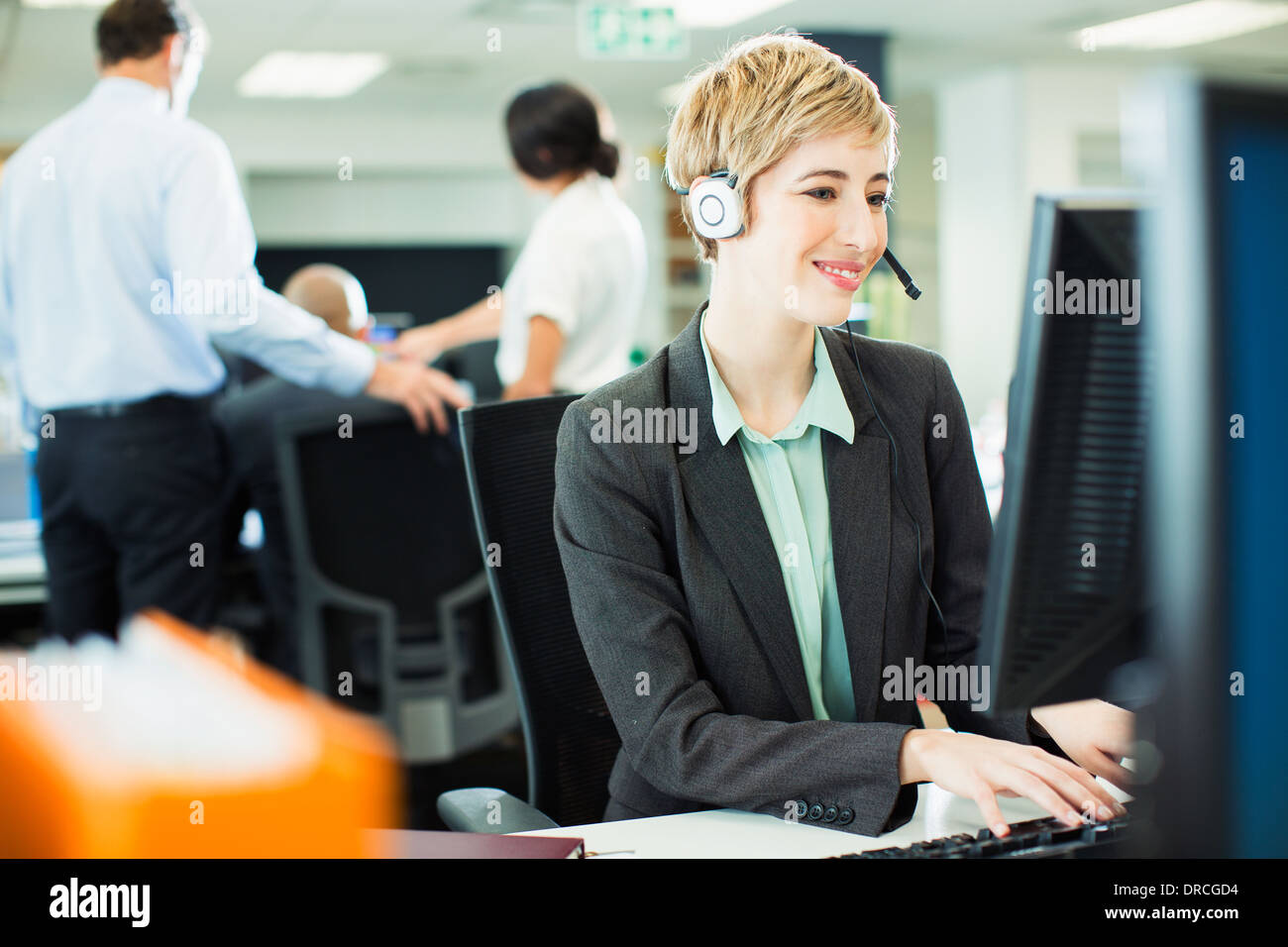Businesswoman talking on headset in office Stock Photo