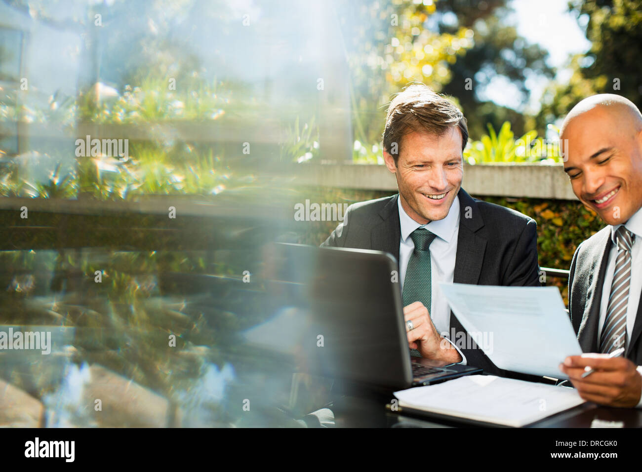 Businessmen working together outdoors Stock Photo