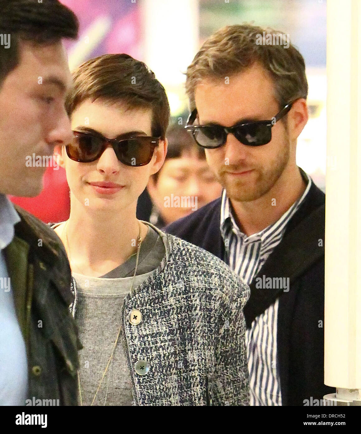 Anne Hathaway and Adam Shulman arriving at Heathrow Airport. Anne is in