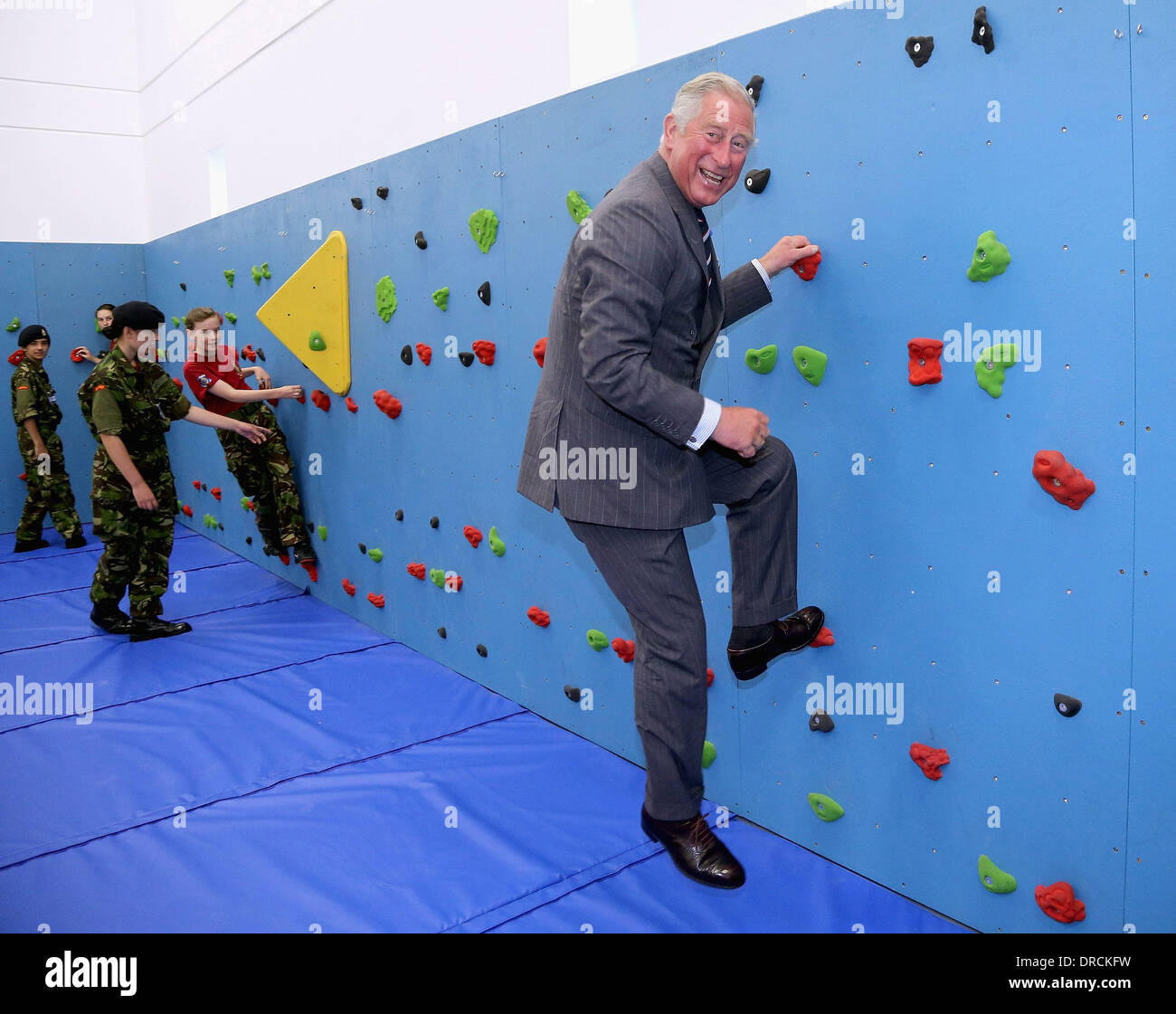 Prince Charles, Prince of Wales climbs on the new traversing wall in