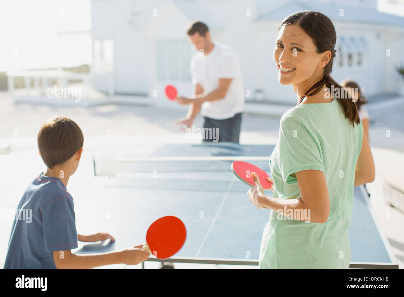 Family playing table tennis together outdoors Stock Photo