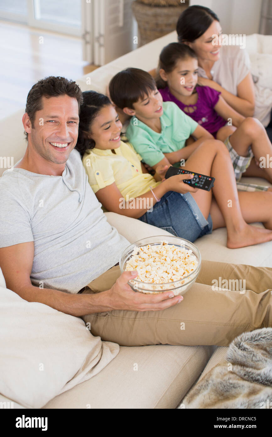 Family watching TV on sofa in living room Stock Photo