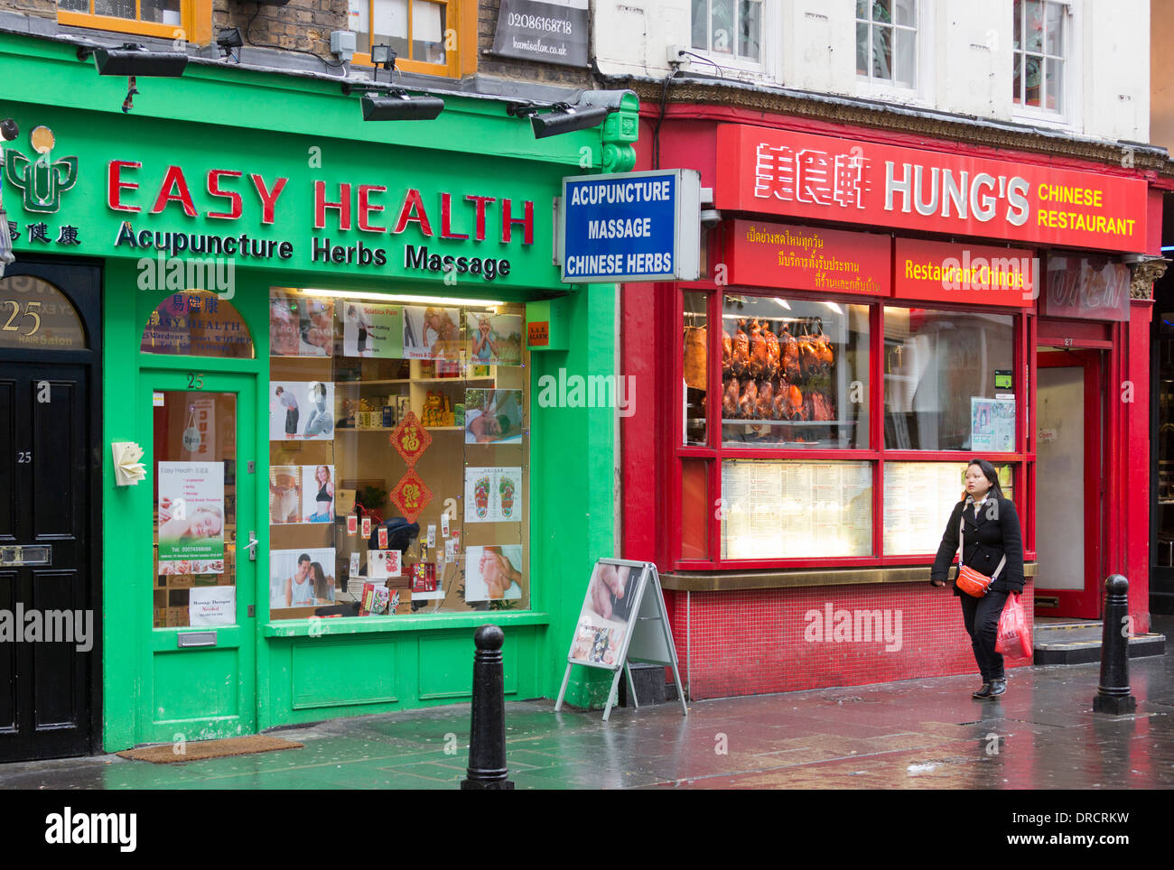 A Woman Walks In Front Of A Shop High Resolution Stock Photography And Images Alamy