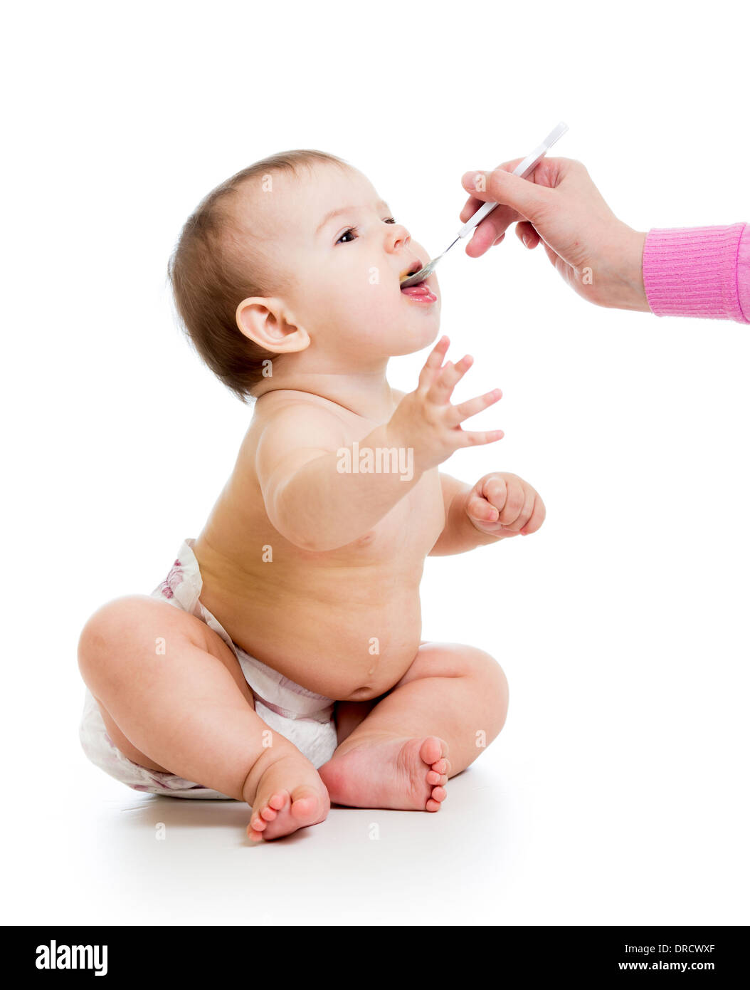 mother feeding baby with a spoon Stock Photo