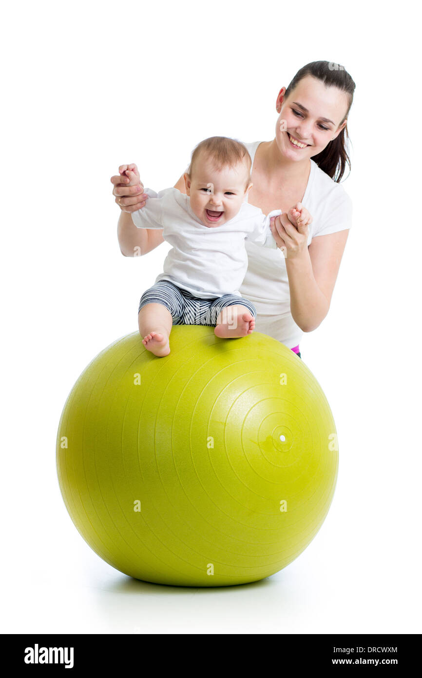 mother playing with baby on fit ball Stock Photo
