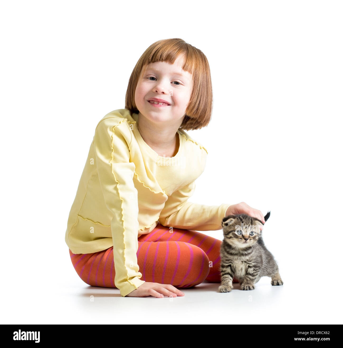 smiling child girl playing with cat kitten Stock Photo - Alamy