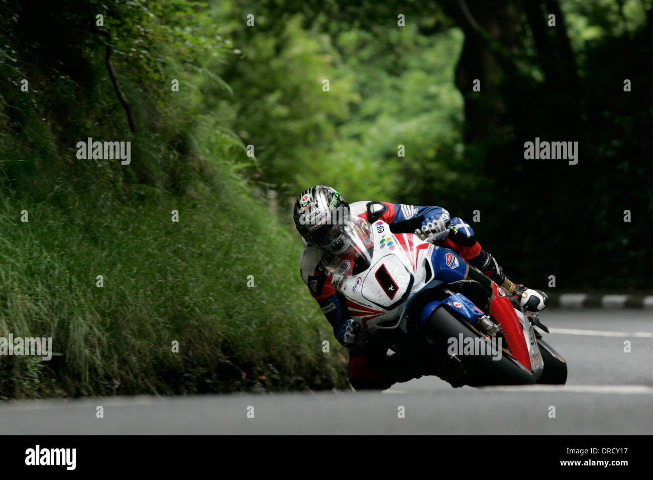 John McGuinness leaving Ramsey Hairpin and approaching the Waterworks during the 2011 Superbike TT race on the Isle of Man. Stock Photo
