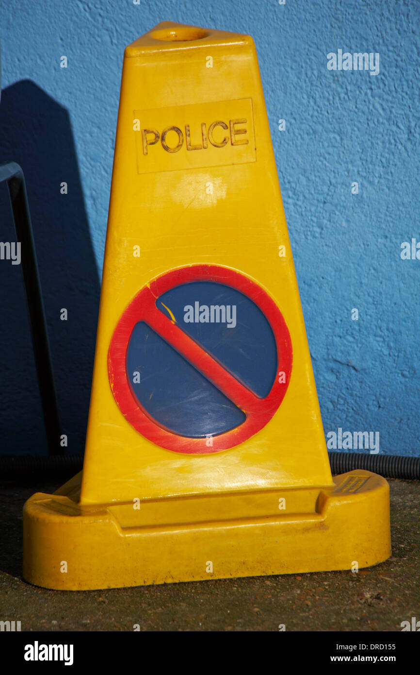 police no waiting cone in front of blue wall Stock Photo