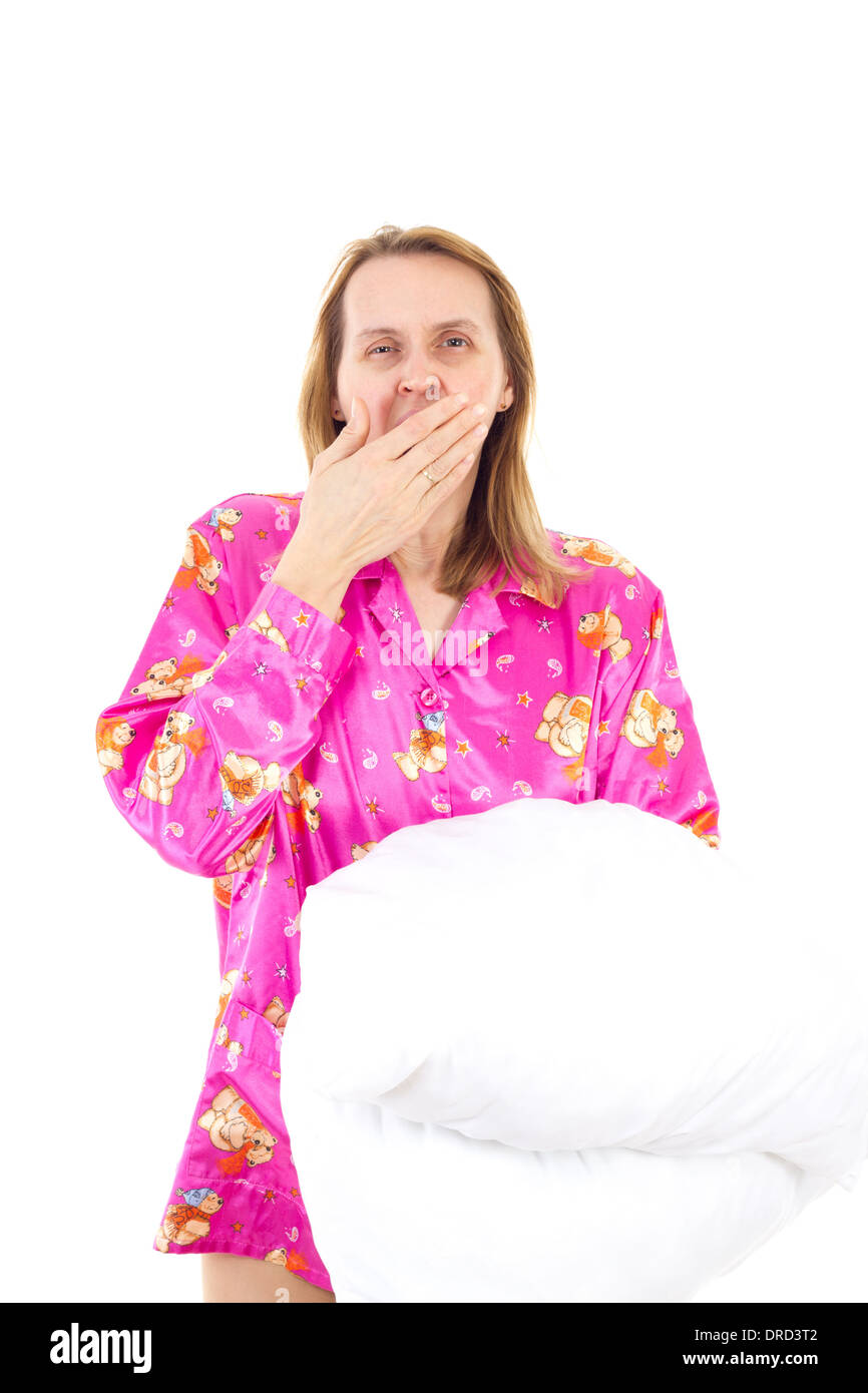 Beautiful woman with pillow yawns Stock Photo