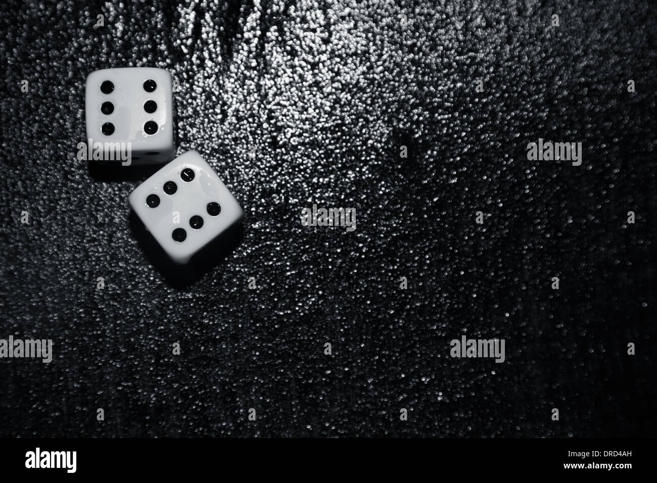 Gambling dices on a wet surface Stock Photo