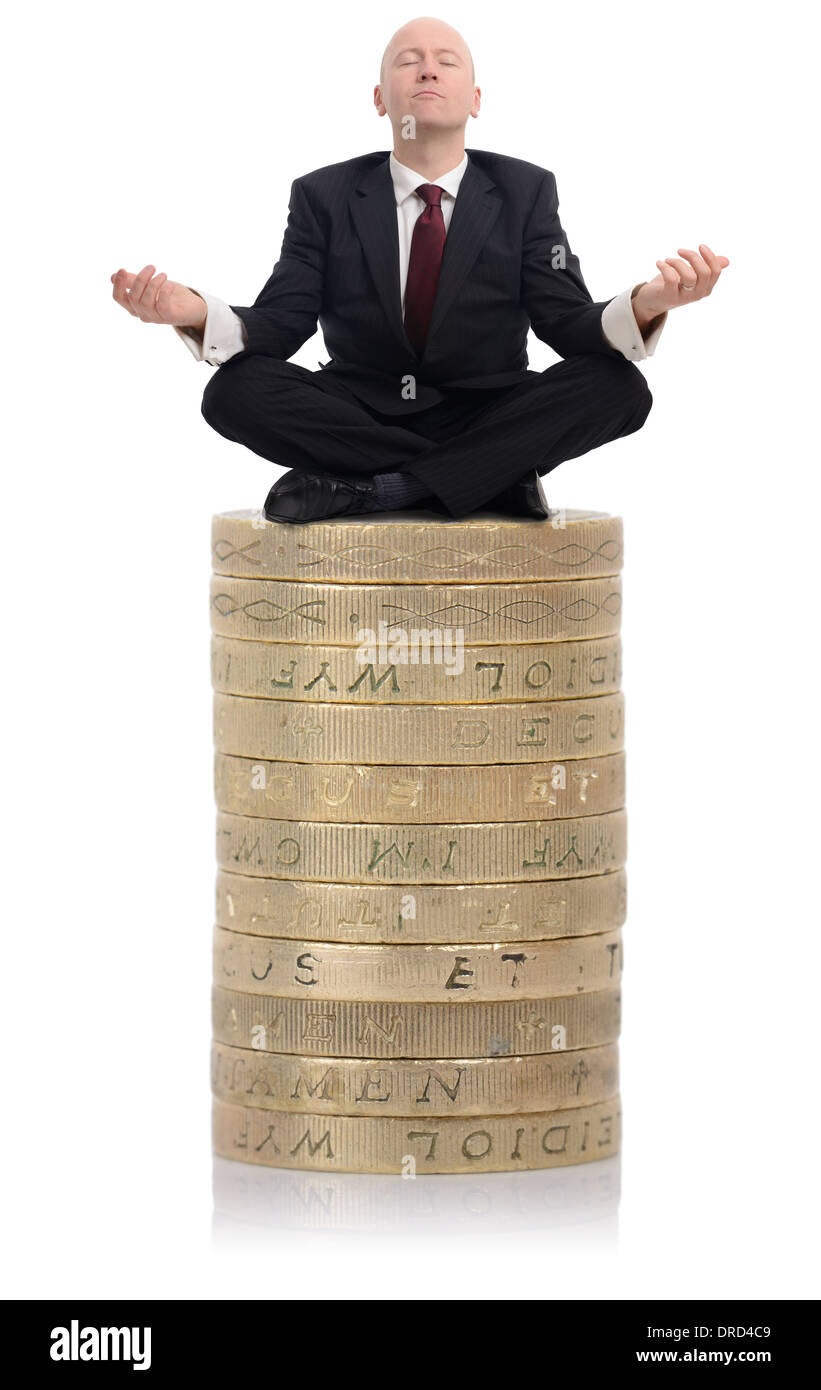 Financial Advisor sat on a stack of money Stock Photo