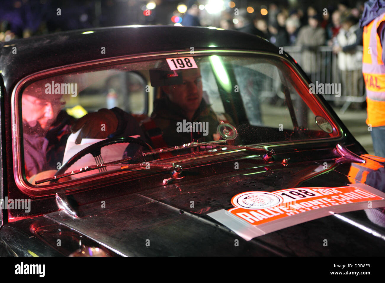Paisley, Scotland, UK. 23rd January 2014. Driver Malcolm Oswald in a Riley 1.5 does some final checks seconds before the UK start of the Rallye Monte-Carlo Historique in Paisley. Credit:  PictureScotland/Alamy Live News Stock Photo
