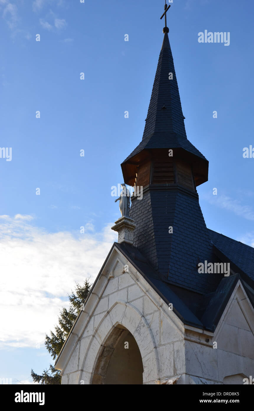 Church spire against blue sky Stock Photo