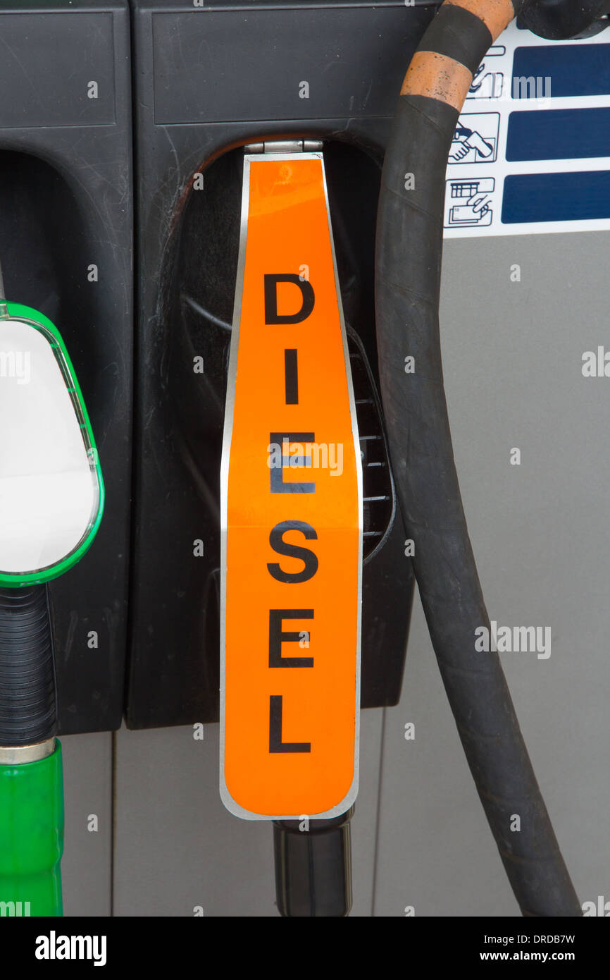 Fuel nozzle behind orange flap indicating diesel at gas station Stock Photo