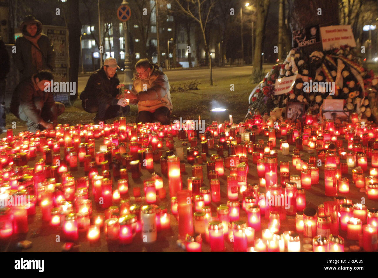 Bucharest, Romania. 23rd January 2014. Local people light candles to ...