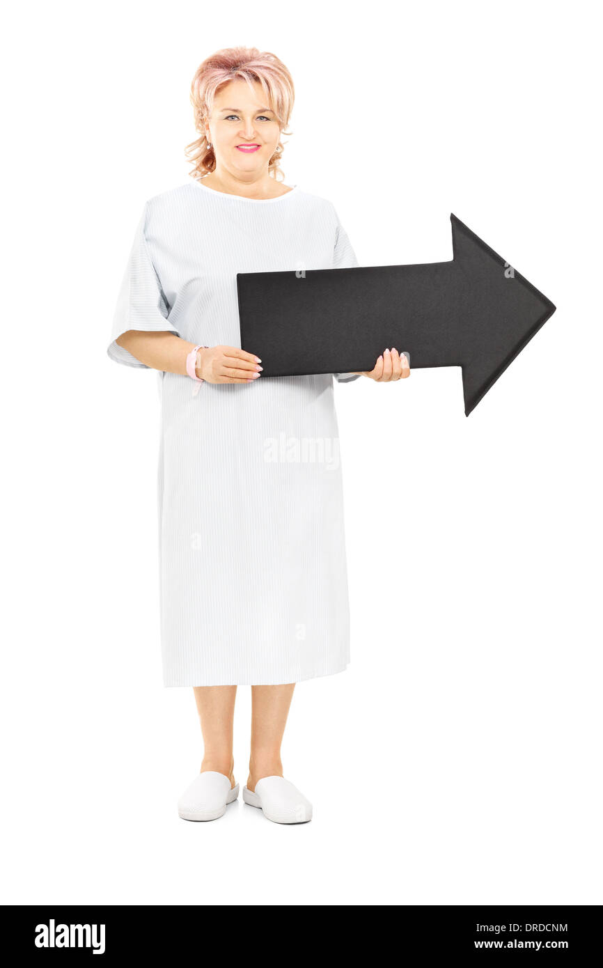 Full length portrait of female patient in hospital gown holding big ...