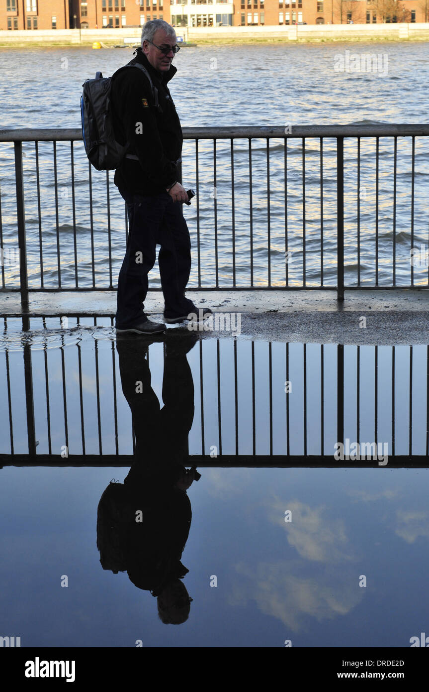 A man and his reflection in water, London, UK Stock Photo