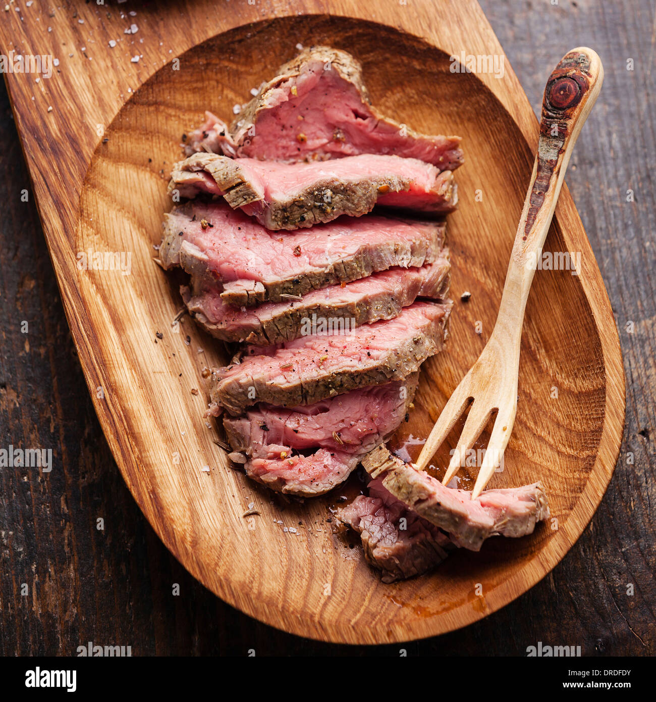 Roast beef and wooden fork Stock Photo