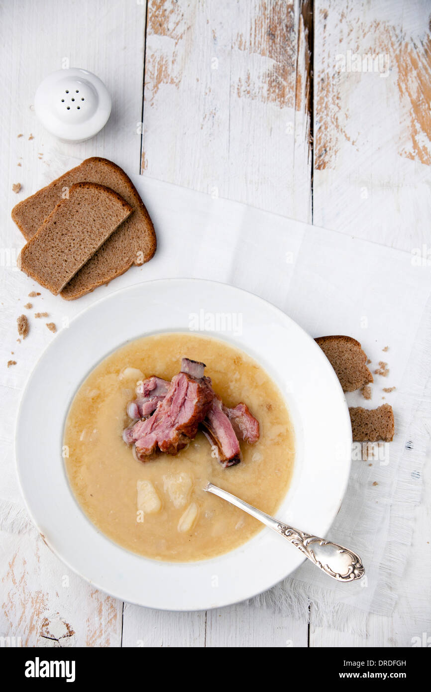 Pea soup with bread and smoked ribs Stock Photo