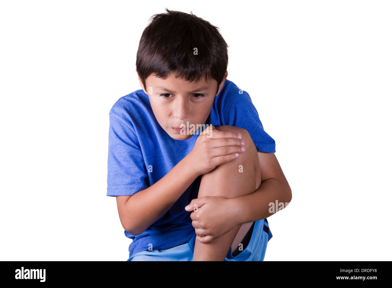 Young boy with hurt sprained knee - on white background Stock Photo