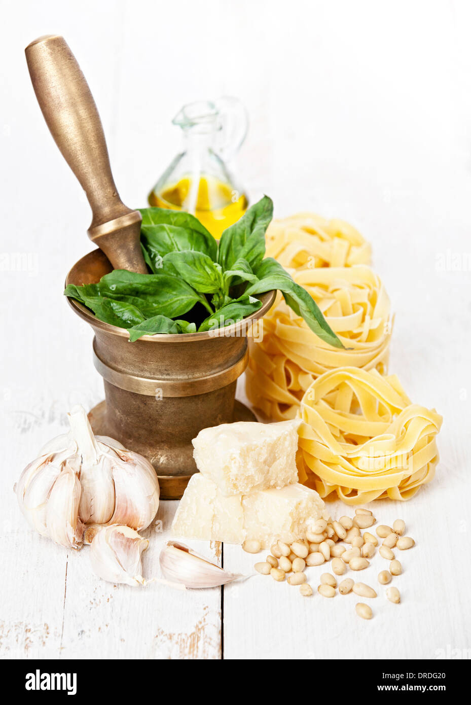 Preparing pesto in mortar on white wooden background Stock Photo Alamy