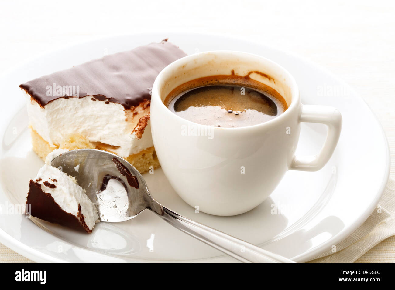 Espresso cup with chocolate covered Marshmallow on white plate Stock Photo