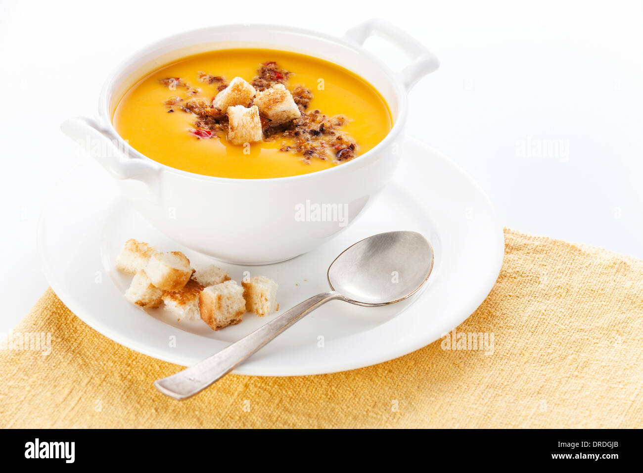 Pumpkin soup with croutons on white background Stock Photo - Alamy