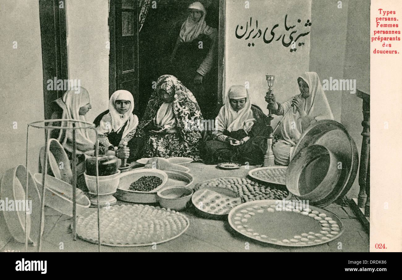 Arab women preparing trays of sweetmeats Stock Photo