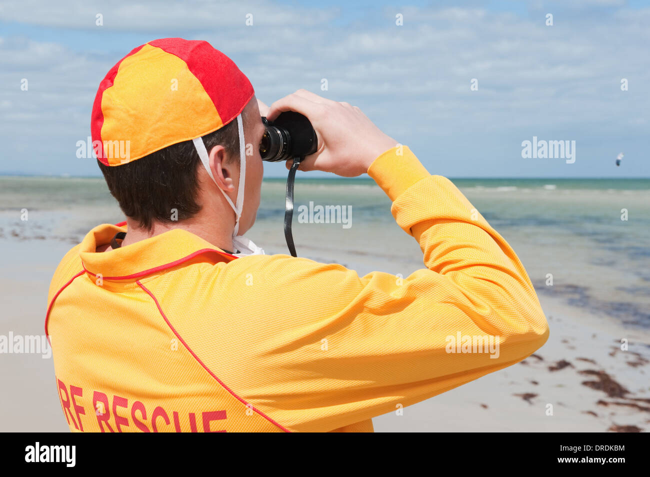 young man life saver watching the situation on the sea Stock Photo