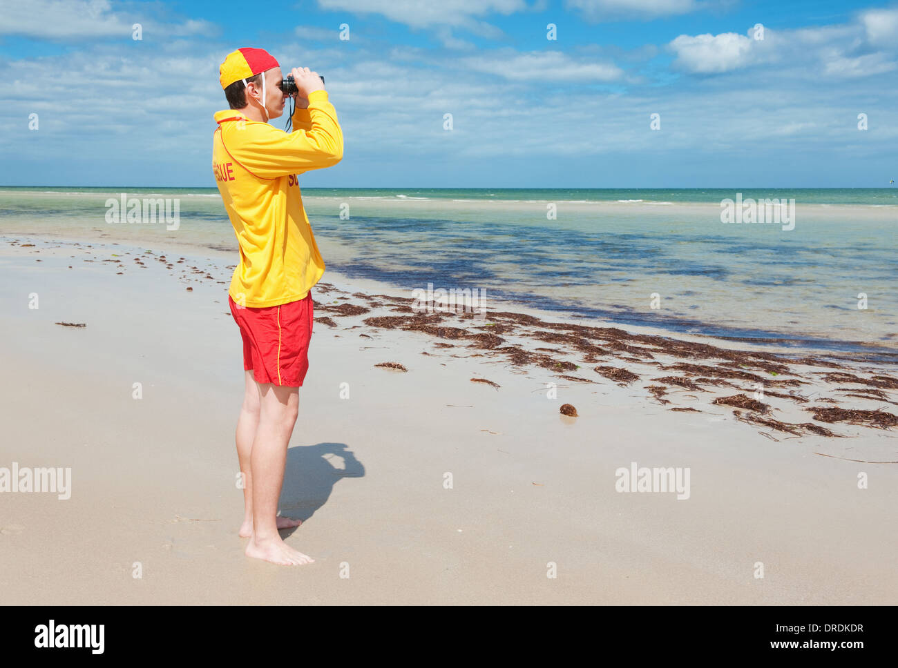 young man life saver watching the situation on the sea Stock Photo