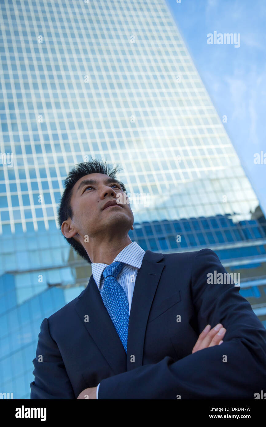 Business executive in front of skyscraper building Stock Photo