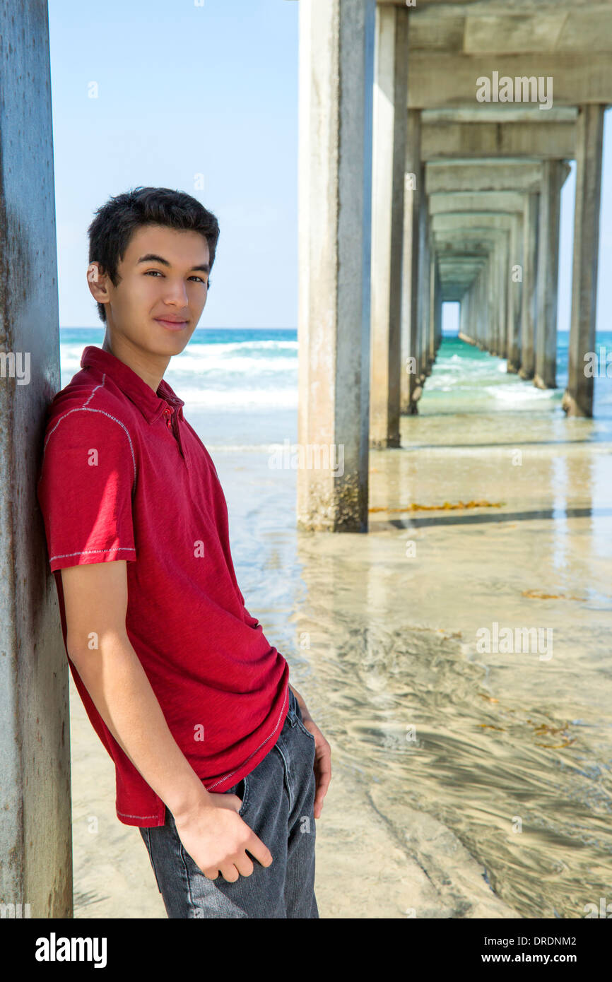 Teenage boy standing by Scripps pier, La Jolla, California Stock Photo