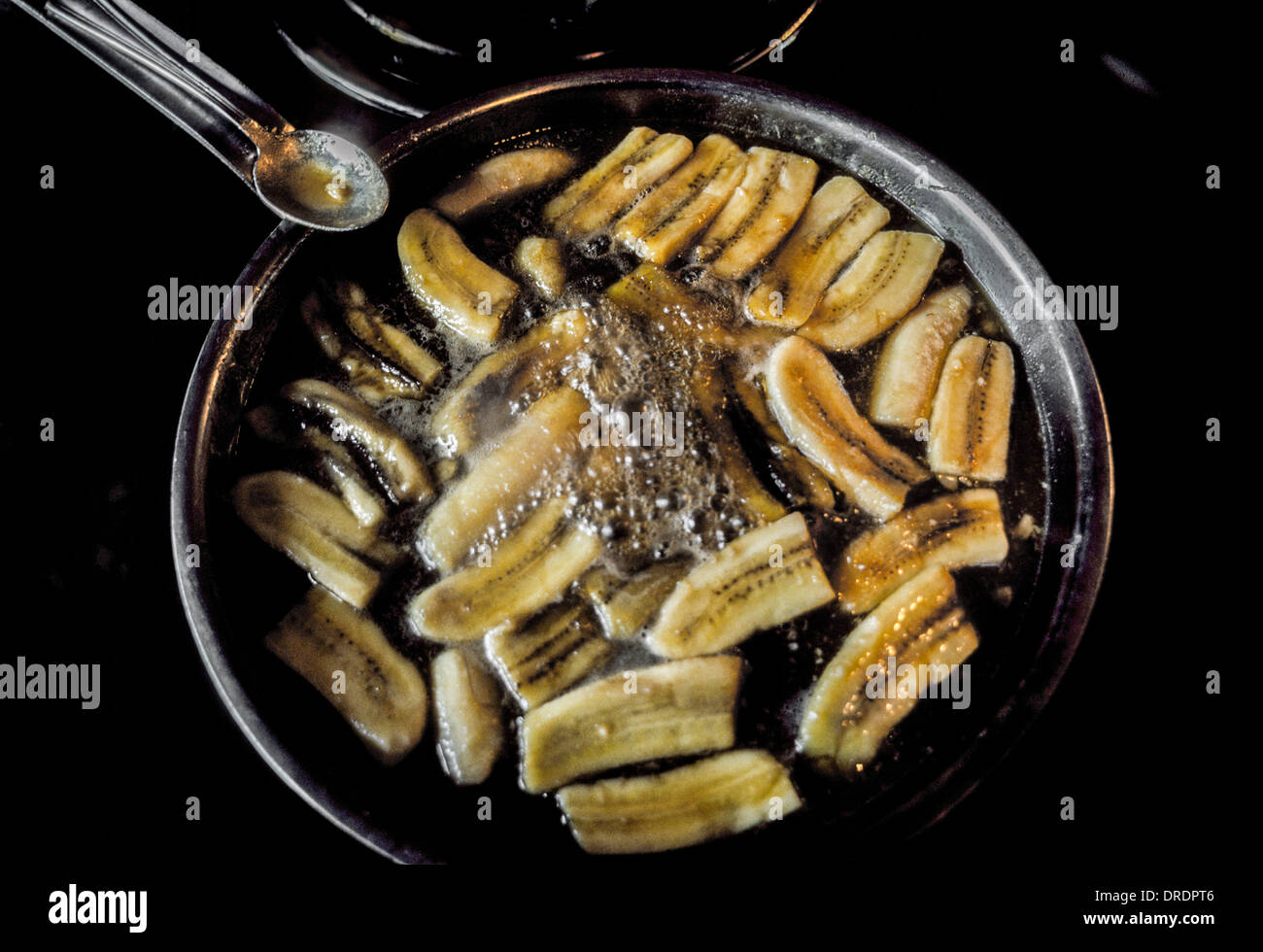 Bananas Foster is prepared in a pan at Brennan's Restaurant in New Orleans, Louisiana, where the dessert originated in 1951. Stock Photo