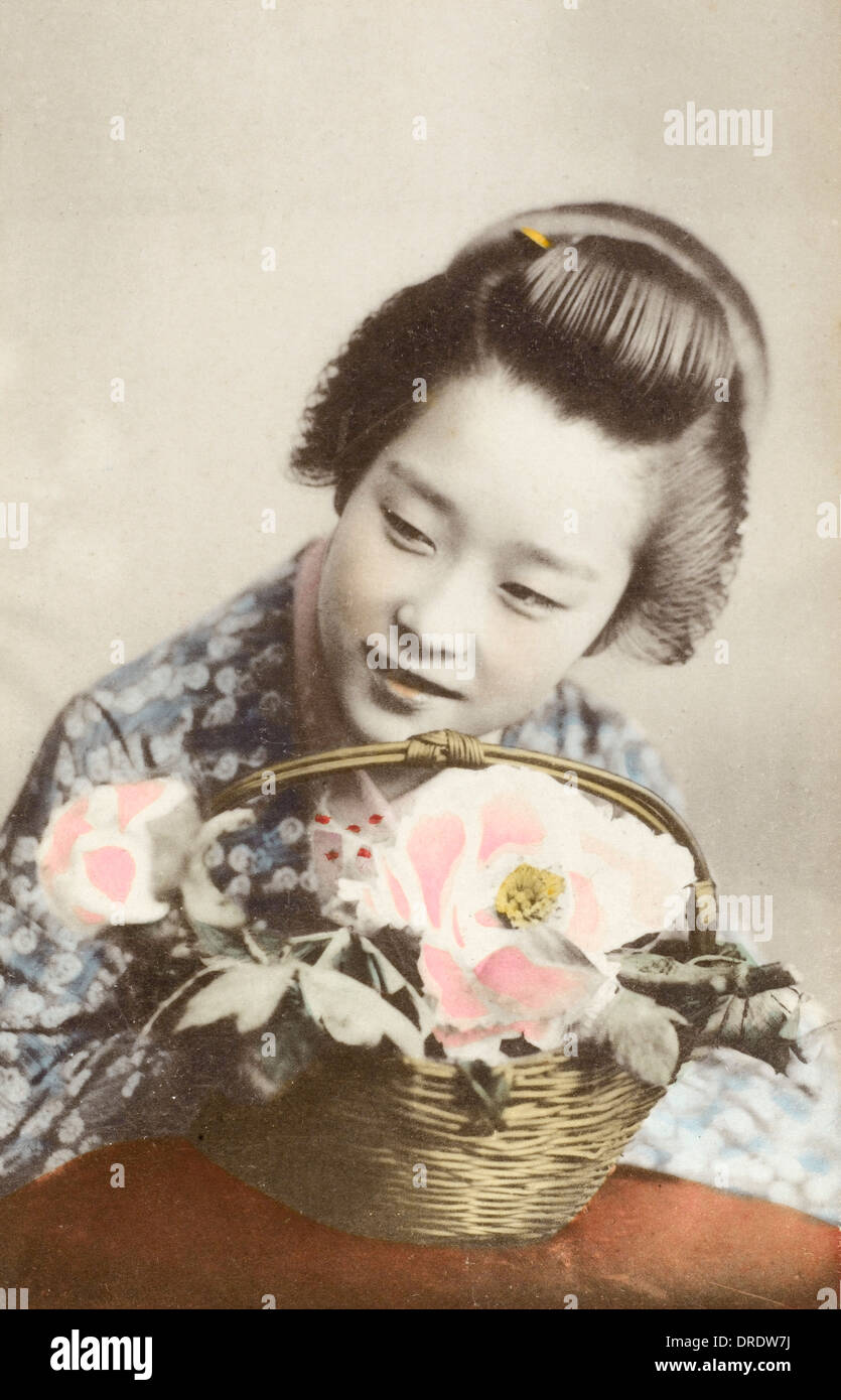 Japan - Geisha girl with a basket of flowers Stock Photo