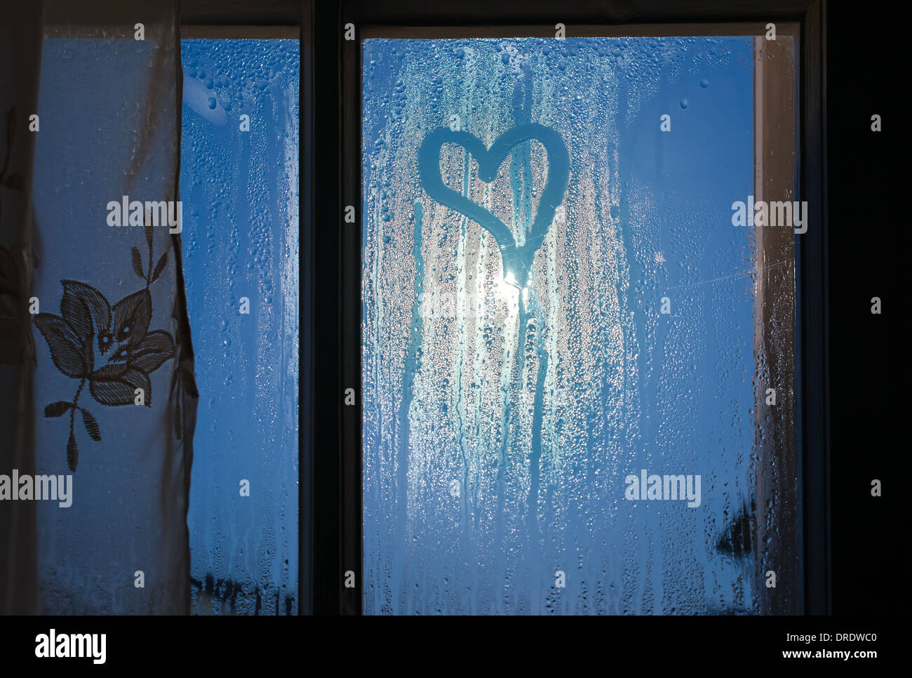 Moonlight through the window. Sweaty glass and heart shape Stock Photo