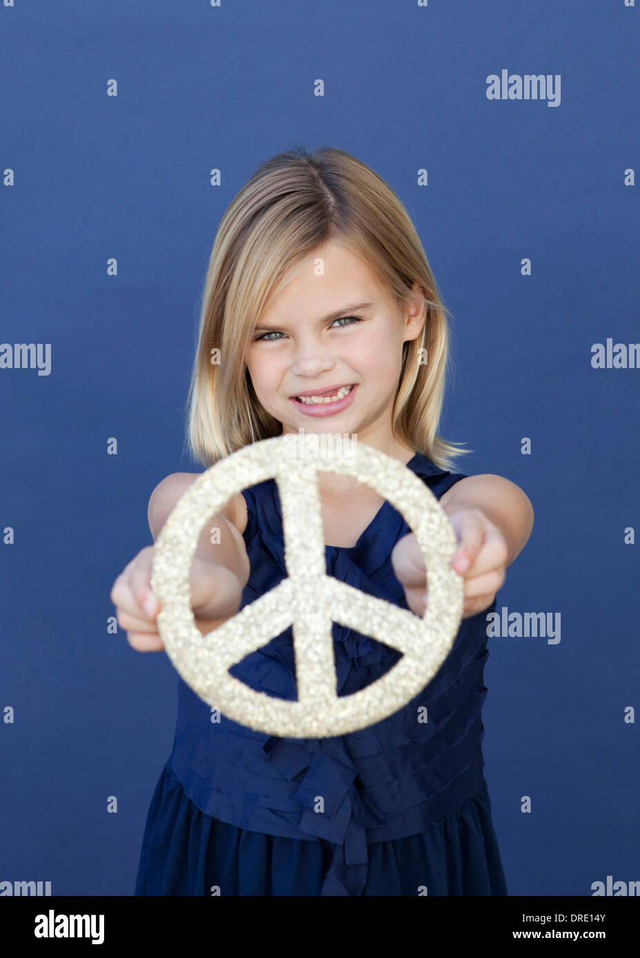 Portrait of young girl holding up peace sign Stock Photo