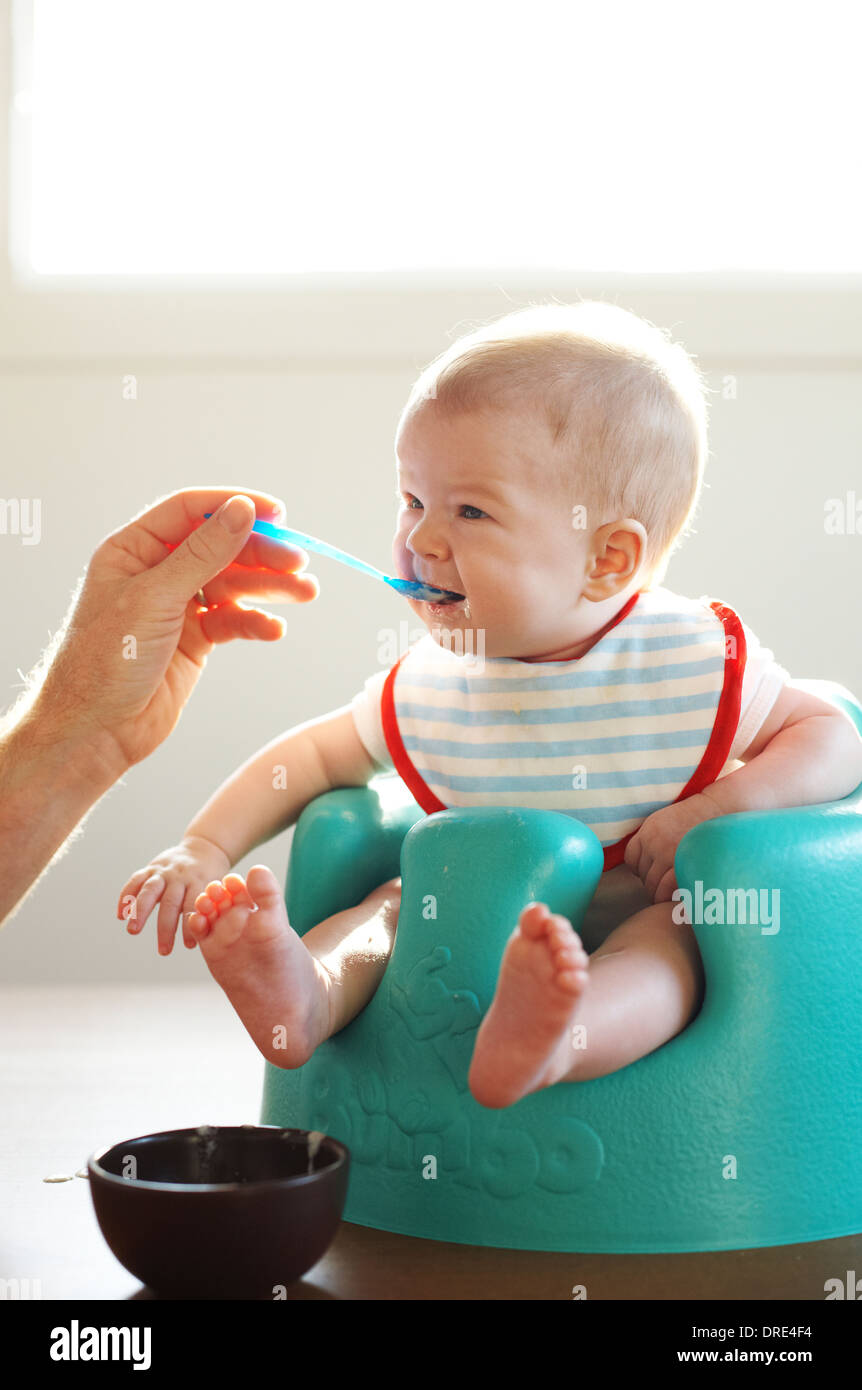 Baby being spoon fed Stock Photo Alamy