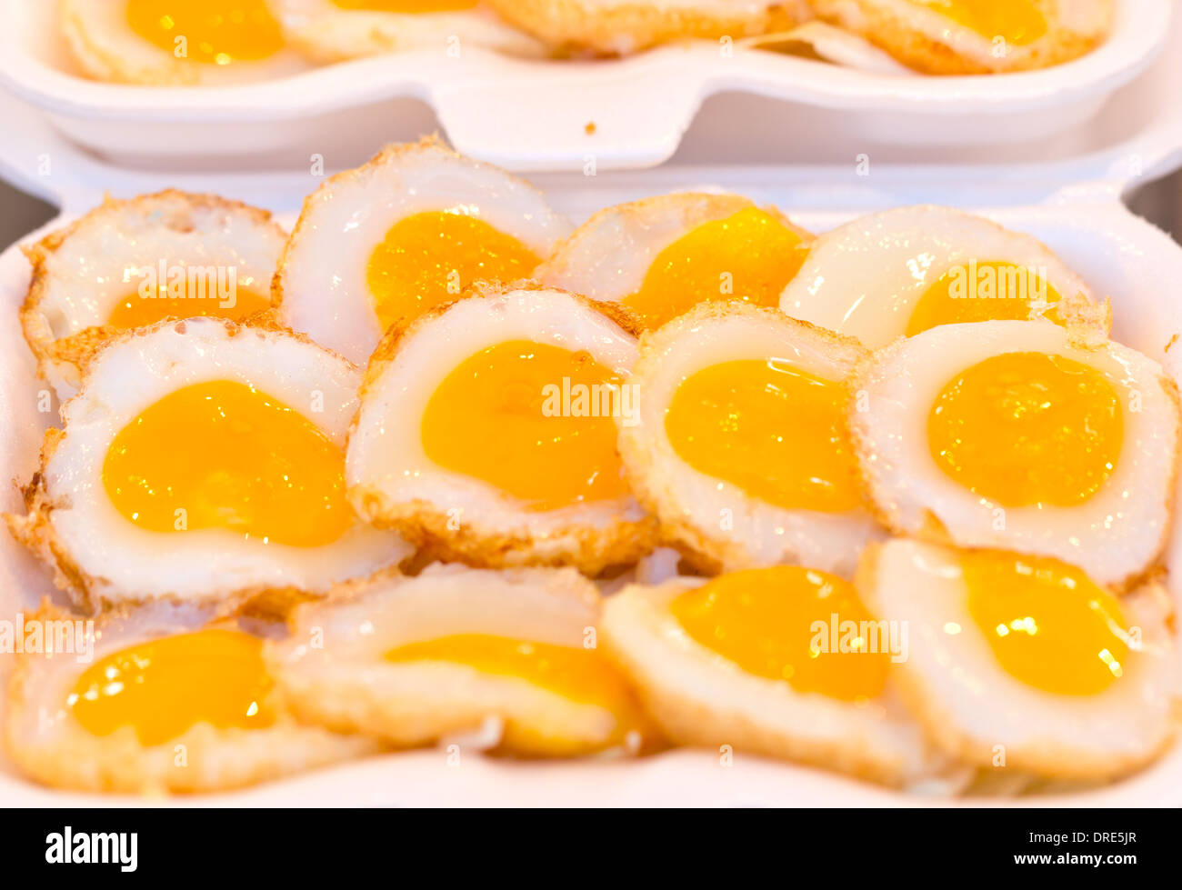 Fried quail egg with foam plate. Stock Photo