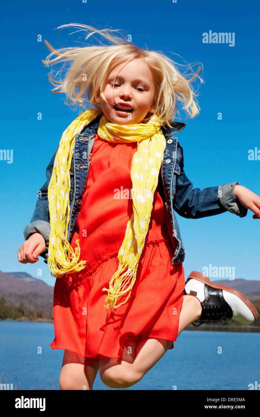 Girl in red dress by lake Stock Photo - Alamy