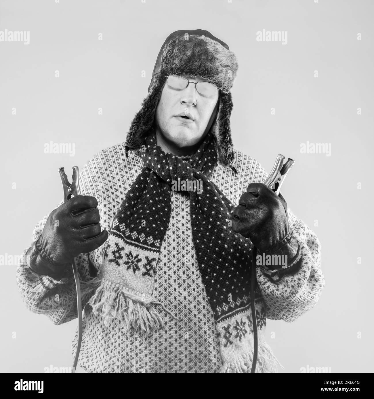 Frozen man with the jumper cables, black and white image Stock Photo