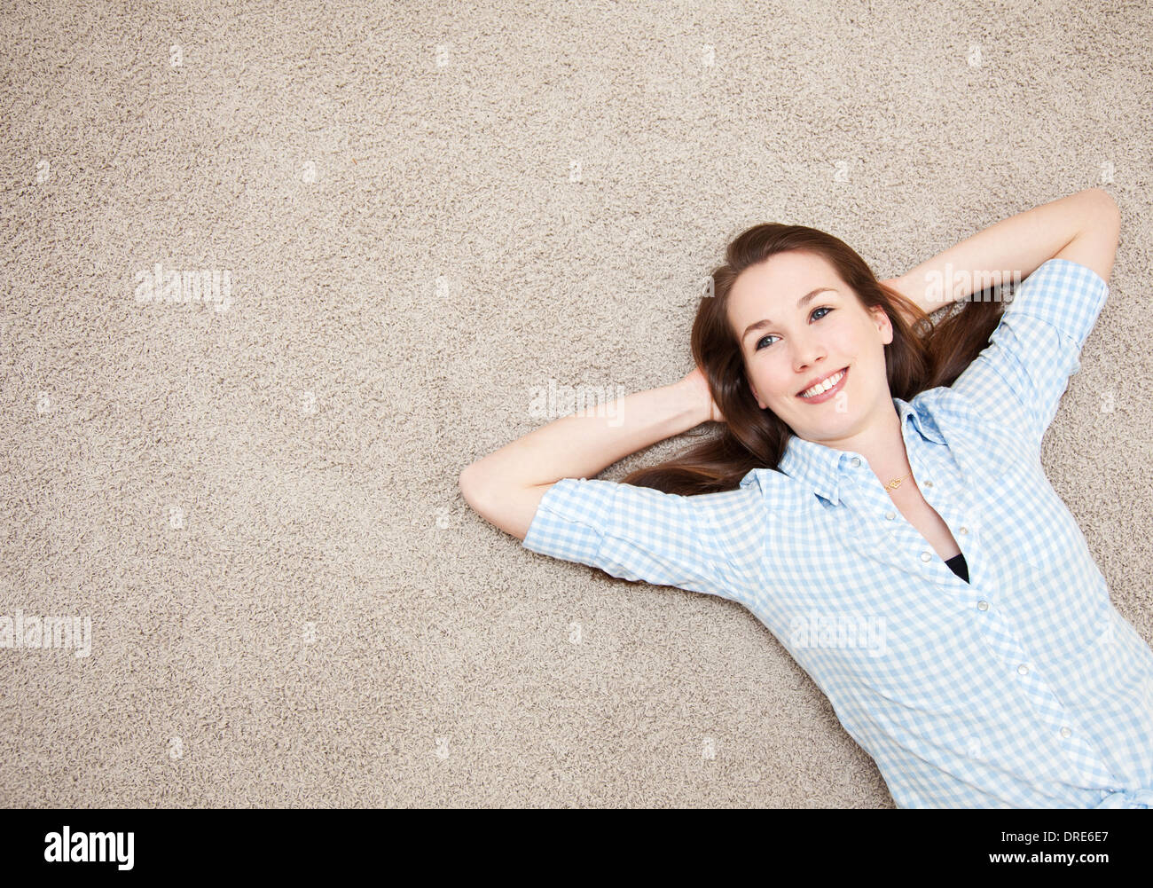 Attractive young woman lying on floor Stock Photo