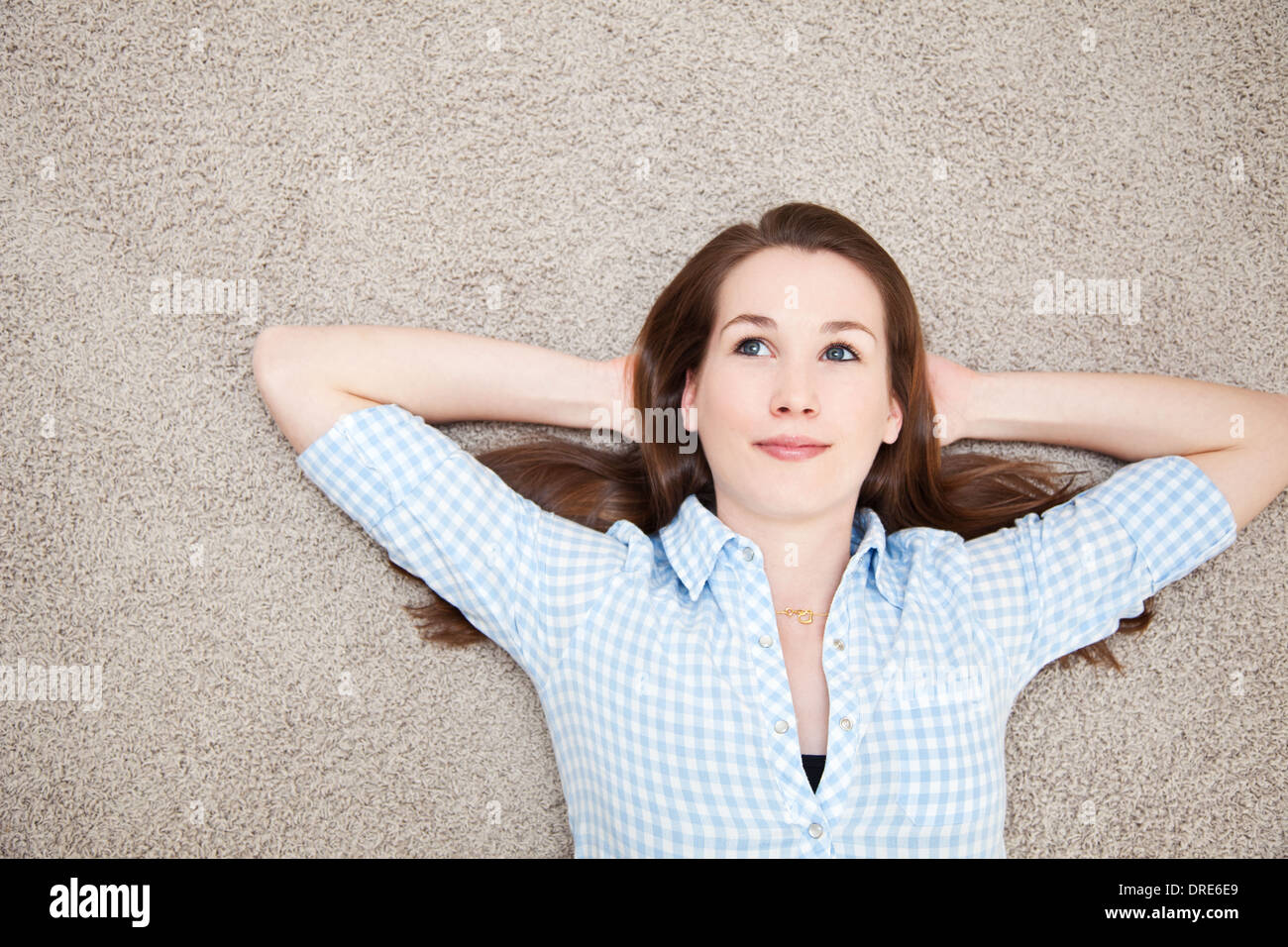 Attractive young woman lying on floor Stock Photo