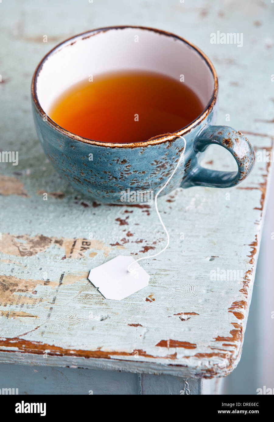 Cup of tea with teabag on blue textural background Stock Photo