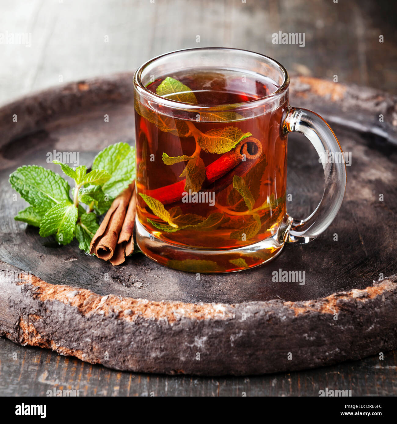 Mint tea with cinnamon on dark background Stock Photo