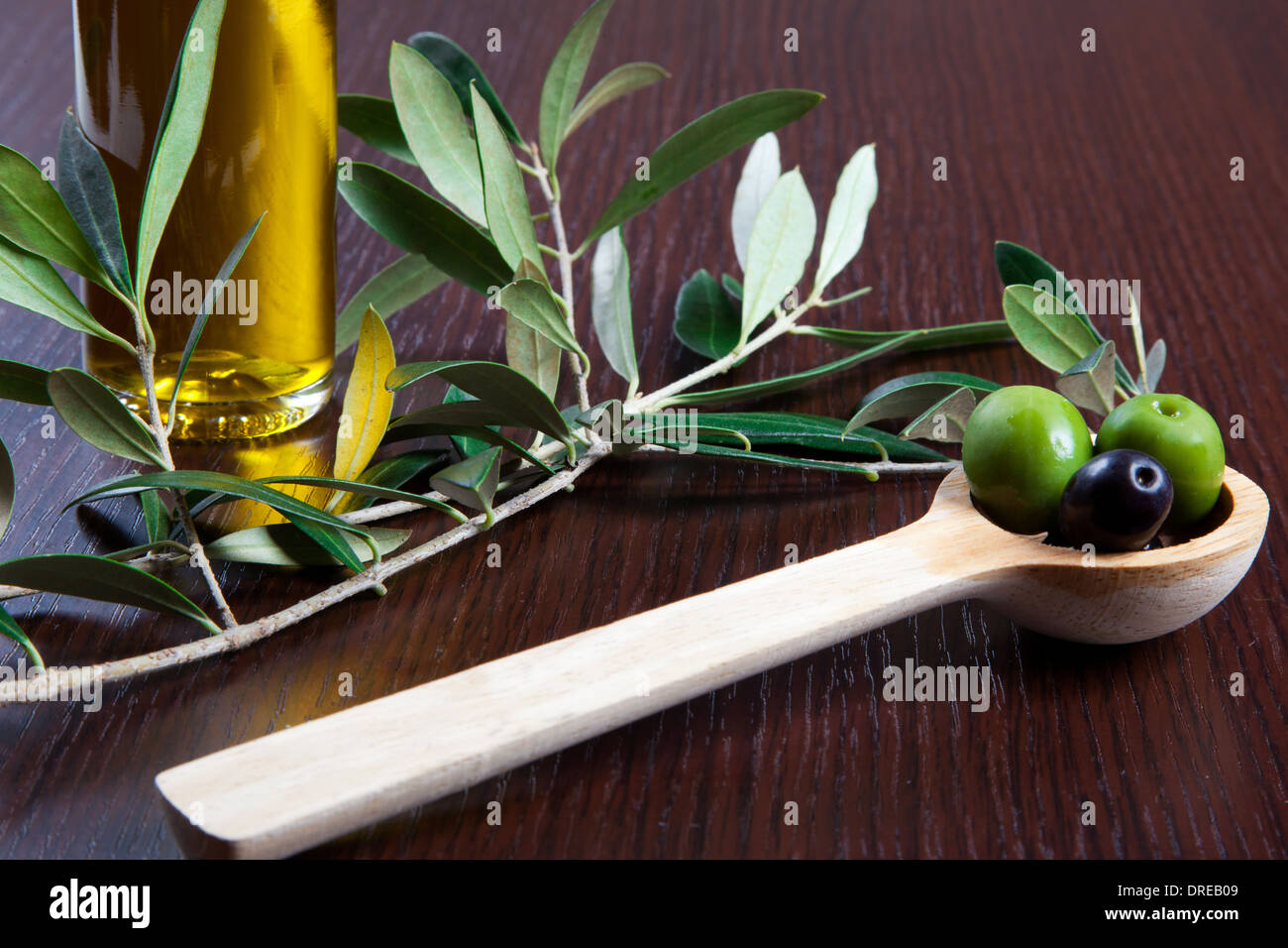 Green olives in a wooden spoon Stock Photo - Alamy