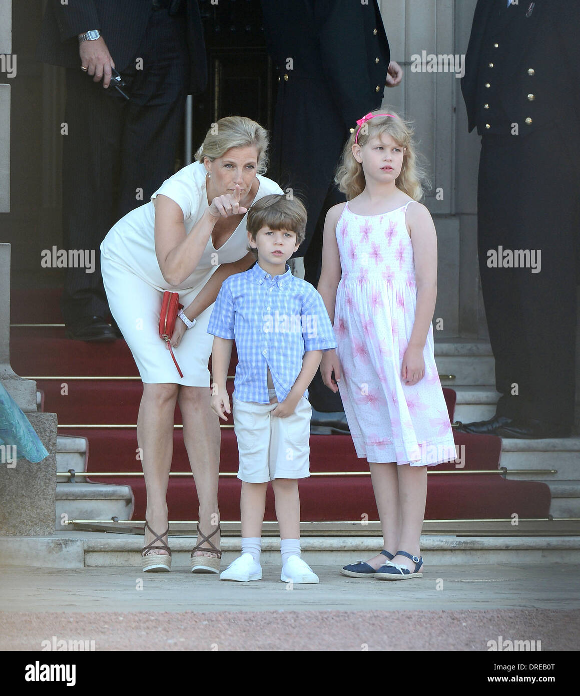 Sophie, Countess of Wessex and daughter Lady Louise Windsor wuith son James, Viscount Severn welcome the Olympic Flame to Buckingham Palace during the Olympic Torch Relay London, England - 26.07.12 Stock Photo