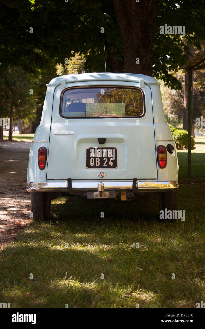 Rear view of pale blue vintage French Renault 4 car in a park in summer, Brantome, Dordogne, France Stock Photo