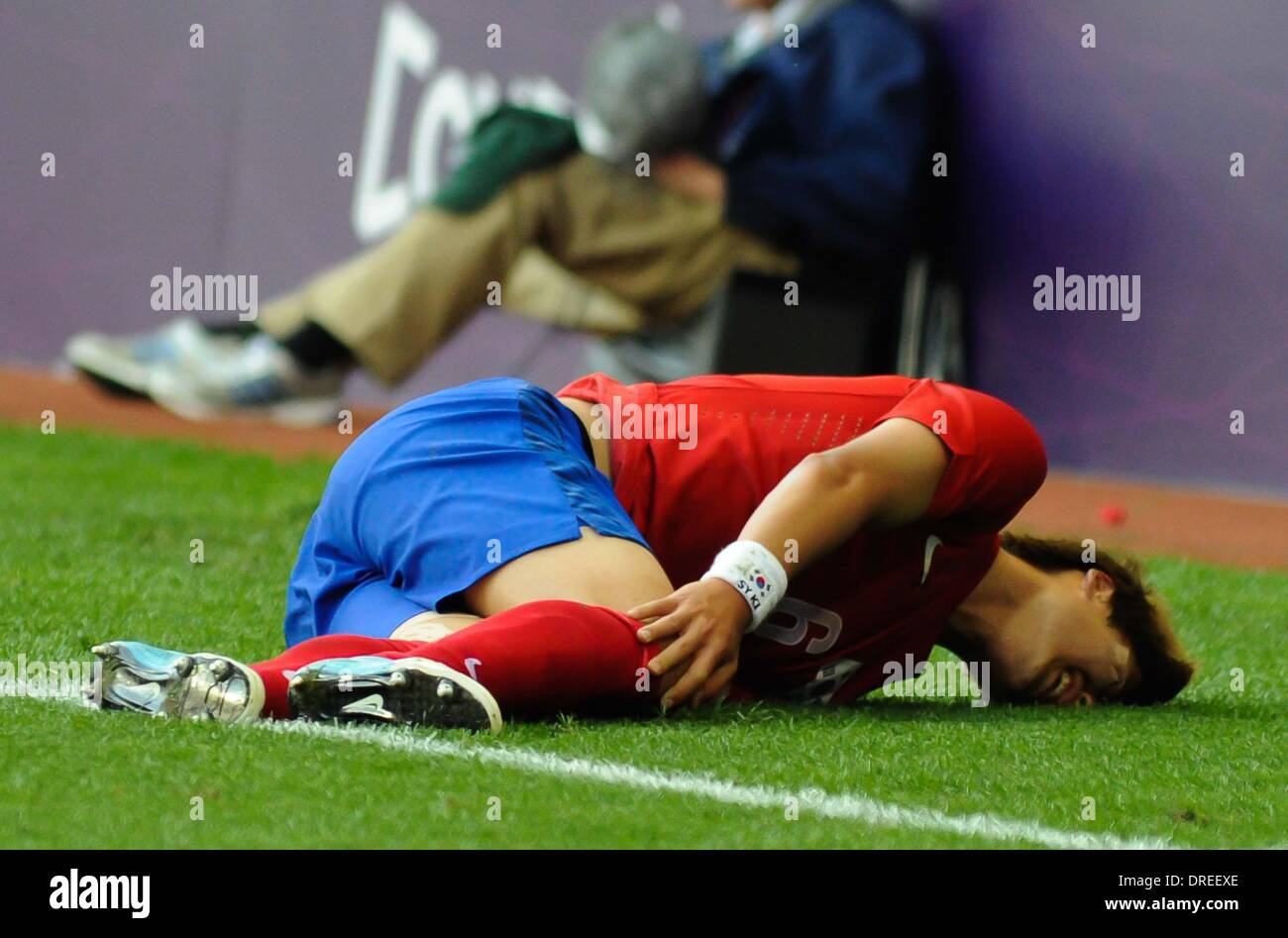 South Korea's Ki Sungyueng lies injured   The Olympic Football Men's Preliminary game between Korea and Switzerland held at the City of Coventry Stadium  Coventry, England - 29.07.12 Stock Photo