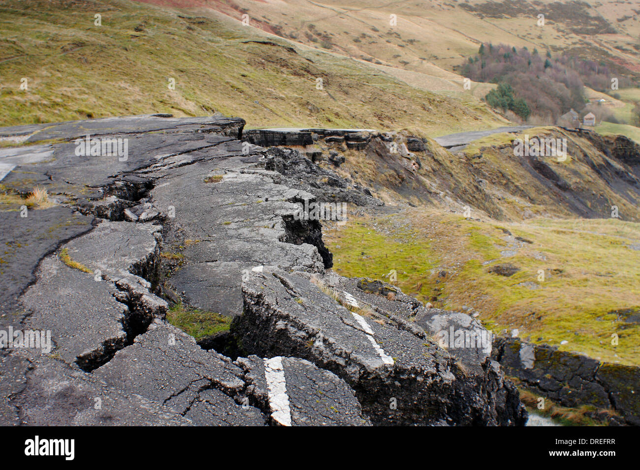 Undulations in a road affected by a major landslip on Mam Tor in the Hope Valley at Castleton, Peak District, Derbyshire, UK Stock Photo